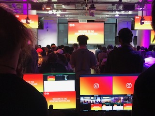 Audience and control monitors during a live Instagram broadcast at a Meta event space